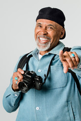 Happy senior man with a digital camera