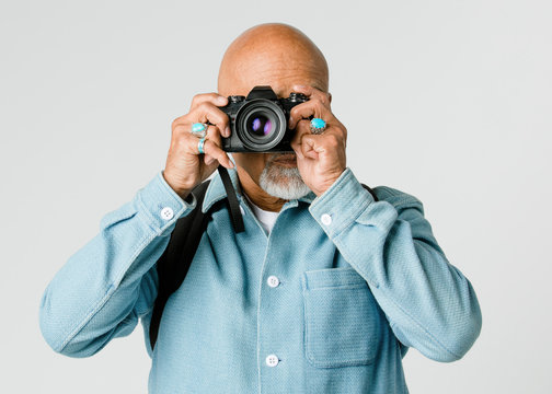 Senior man with a digital  camera