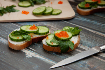 Sandwiches with greens on a wooden background