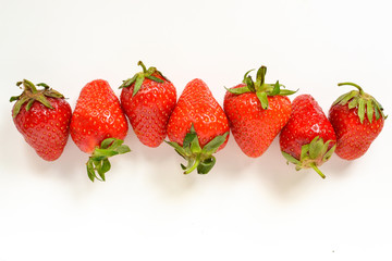 Minimal food concept. Strawberries on a white background. Top view. Free space for text. Tasty berries.