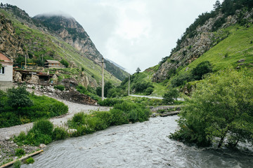 Fototapeta na wymiar North Ossetia Alania, Kurtata gorge, river in Caucasus mountains, village and fortress, Russia