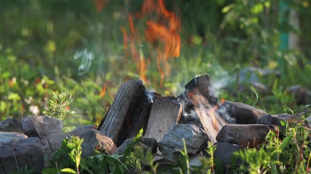 UHD closeup dolly shot of the backyard bonfire, taken with a super tele lens