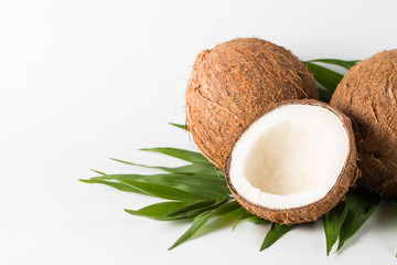 Ripe half cut coconut on a wooden background. Coconut cream and oil.