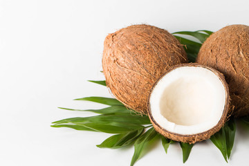 Ripe half cut coconut on a wooden background. Coconut cream and oil.