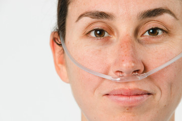 Sick female patient with a nasal cannula - obrazy, fototapety, plakaty