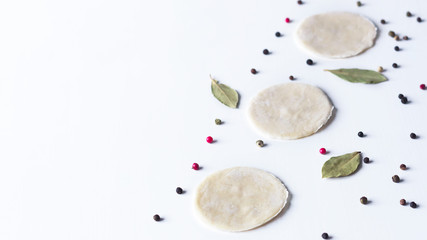 on a white background lay blanks for modeling dumplings: tortillas and spices. sculpt dumplings