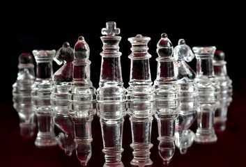 Obraz na płótnie Canvas glass chess pieces on black
