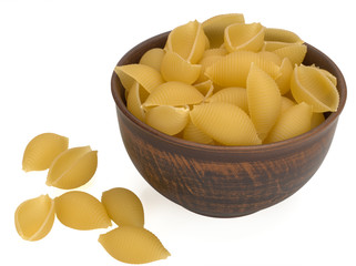 Italy dry raw pasta conchiglie in a bowl and on a white background