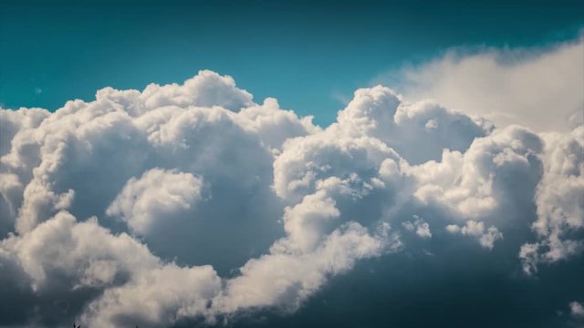 Epic white cumulus clouds rolling over blue sky background. Timelapse, 4K UHD.
