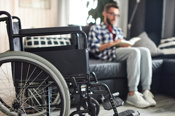Wheelchair standing in front of young man
