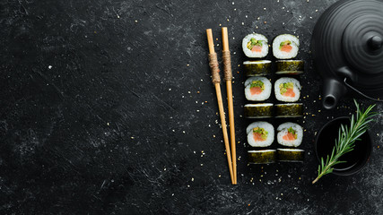 Sushi rolls with avocado and salmon. Classic Japanese sushi. Top view. Free space for your text.