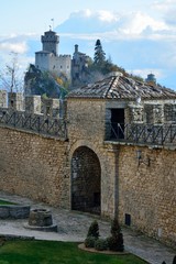 A part of the medieval San Marino city wall with the view of Italian landscape and Fratta or Cesta...