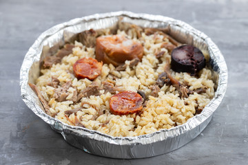 rice with duck and smoked sausages in plastic box