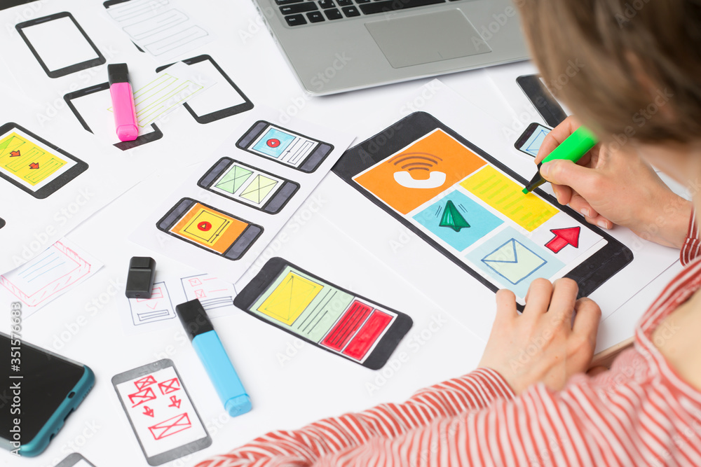 Poster a female designer is developing a web application for mobile phones. woman draws a mock up of interf