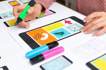 Web designer develops applications for the smartphone. Sketching the interface for a mobile phone....