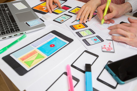 Teamwork of website designers. Development of sketch interfaces for mobile phone applications. Brainstorming and discussion of ideas.