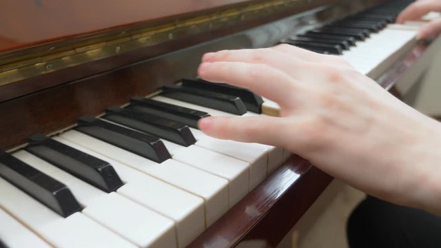 closeup. female hands masterfully play the arpeggio on the piano