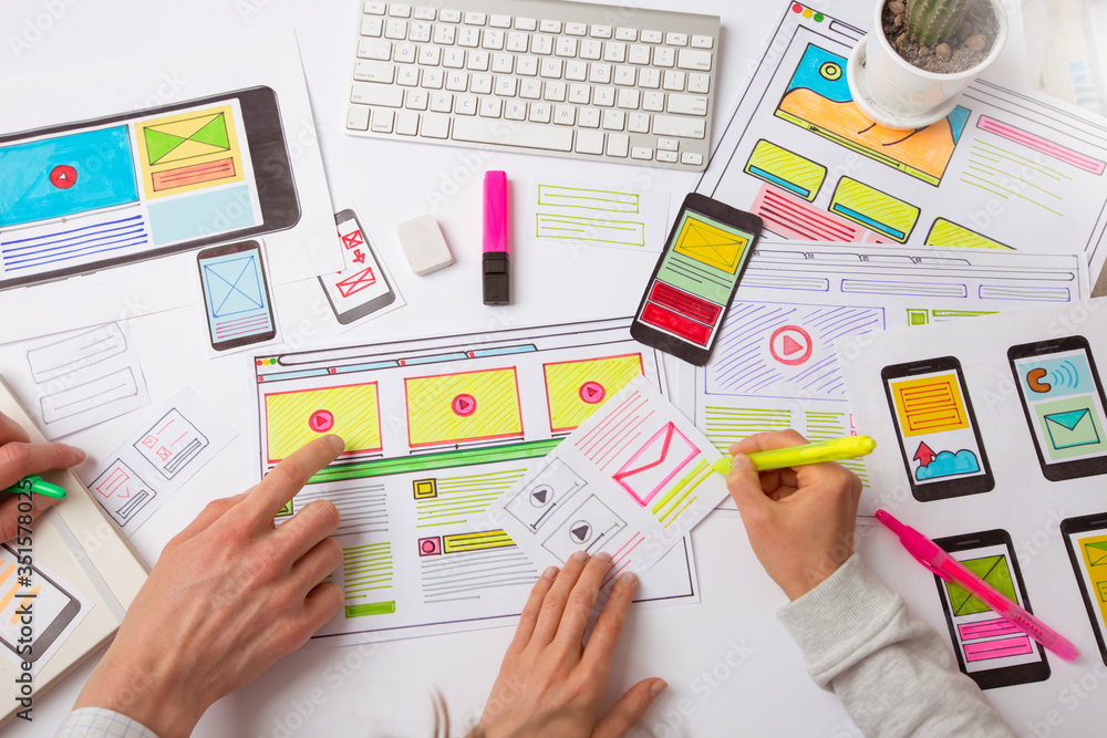 Aufkleber designers develop website applications. designers draw sketches of the interface. user experience co