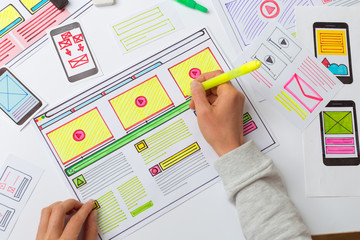 Web designer draws sketches for applications on the desktop. Development user interface. UX / UI Design Concept.