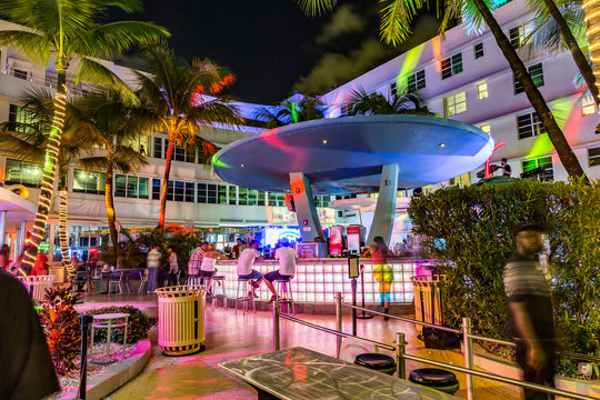 people enjoy nightlife at Ocean Drive along South Beach Miami in the historic Art Deco District with hotels, restaurant and bars