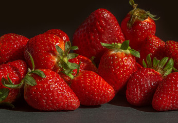 Bright red strawberries on a black background.
