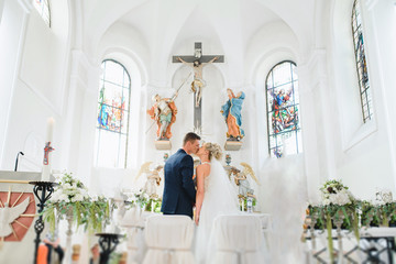 classic church wedding - bride and groom kiss