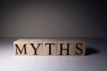 Myths word written on wood block. myths text on table, concept.