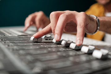 Man with stage mixer controller for audio