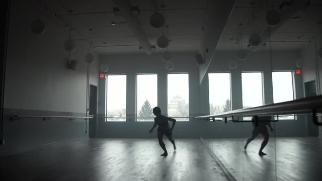 Modern contemporary dancer dancing in dance studio, wide push in
