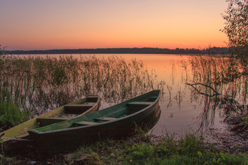Fototapeta na wymiar wooden boats near the shore at sunset
