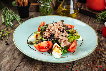 Gourmet tuna salad with eggs greens and sauce