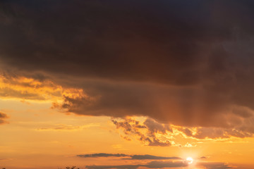 orange sunset sky with lighted clouds