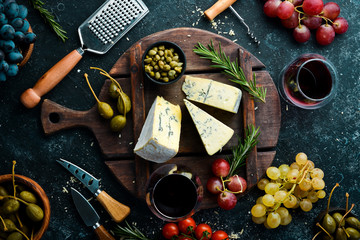 Blue cheese with mold on old table with spices. Top view. Free space for your text.