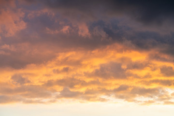 Naklejka na ściany i meble orange sunset sky with lighted clouds