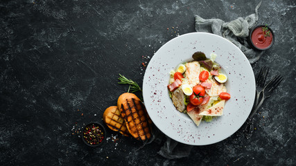 Caesar salad with chicken in a plate. Vegetable salad. Top view. Free copy space.