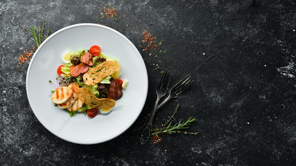 Vegetable salad with chicken fillet and bacon. Top view, free space for your text. Rustic style.
