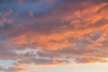 orange sunset sky with lighted clouds