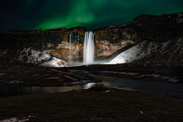 Fototapeta na wymiar Beautiful Waterfall in Iceland with Northern Light.
