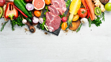 Protein menu: veal meat, vegetables and fruits. Food background.