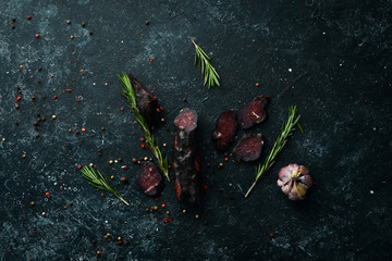 Dry, salted veal meat with spices. Top view. Free space for your text.