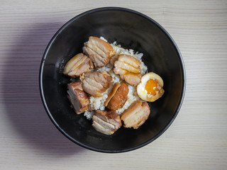 A bowl of kakuni, braised pork belly, on top of white rice.