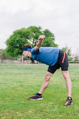 Obraz premium Athlete does warm-up before running at stadium