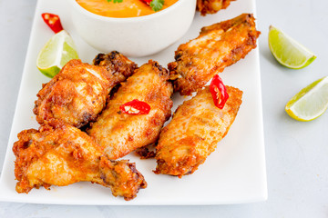 Crispy Fried Chicken Wings in a Platter with Dip Sauce on White Background Horizontal Stock Photo

