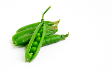 fresh, young green peas on a white background, the concept of a healthy diet vegetarianism