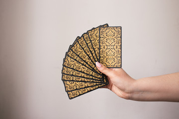 woman hands with tarot cards on the white background