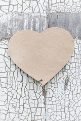 Paper heart on a rustic wall, door as a symbol of love