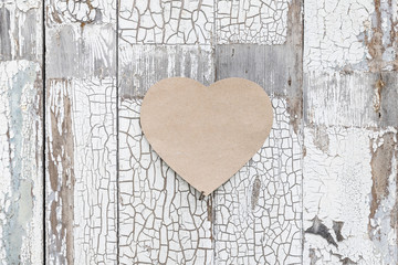 Paper heart on a rustic wall, door as a symbol of love