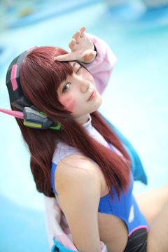 Japan anime cosplay , portrait of cosplay girl with swim suit at swimming pool