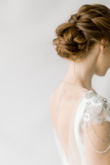 
hairstyle of the bride in a wedding dress, a bun of curly red hair