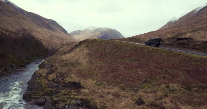 Discovery speeds over mountain road in beautiful Glen Etive, Scotland